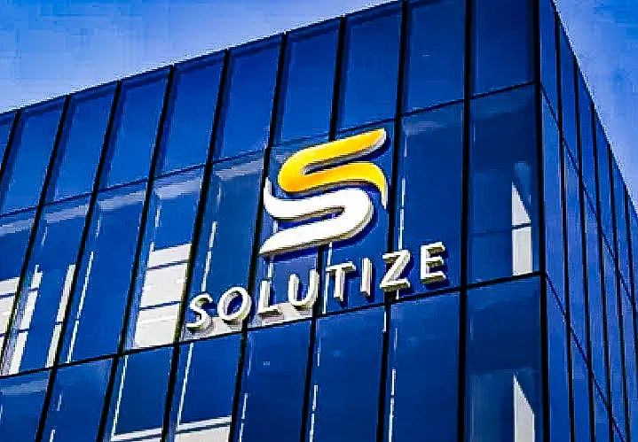 Commercial exterior with blue glass building and Solutize logo and signs