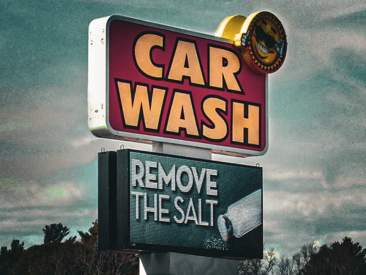 Commercial car wash exterior sign with digital message board and awnings
