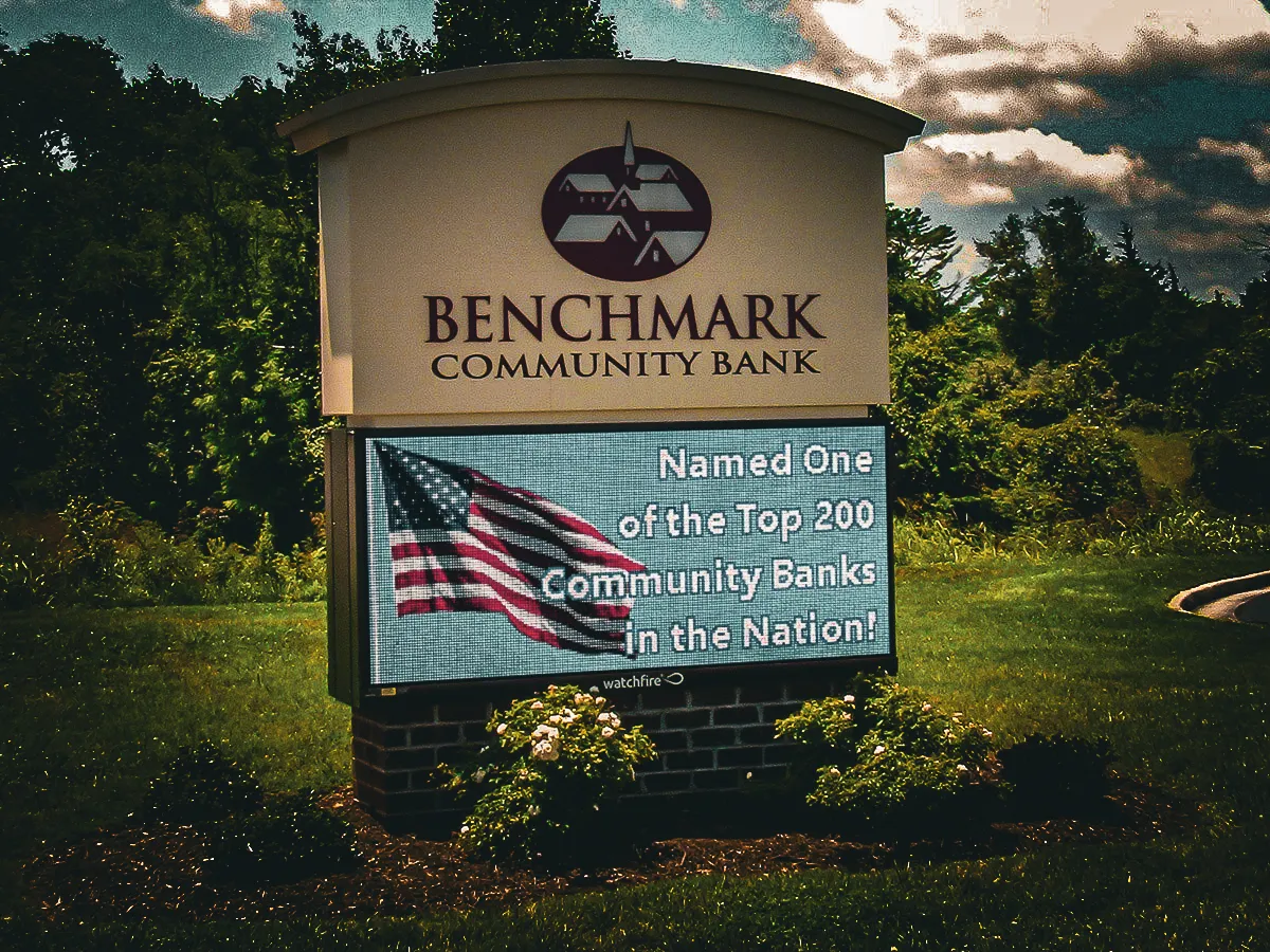 Commercial exterior sign for Benchmark Community Bank with digital display