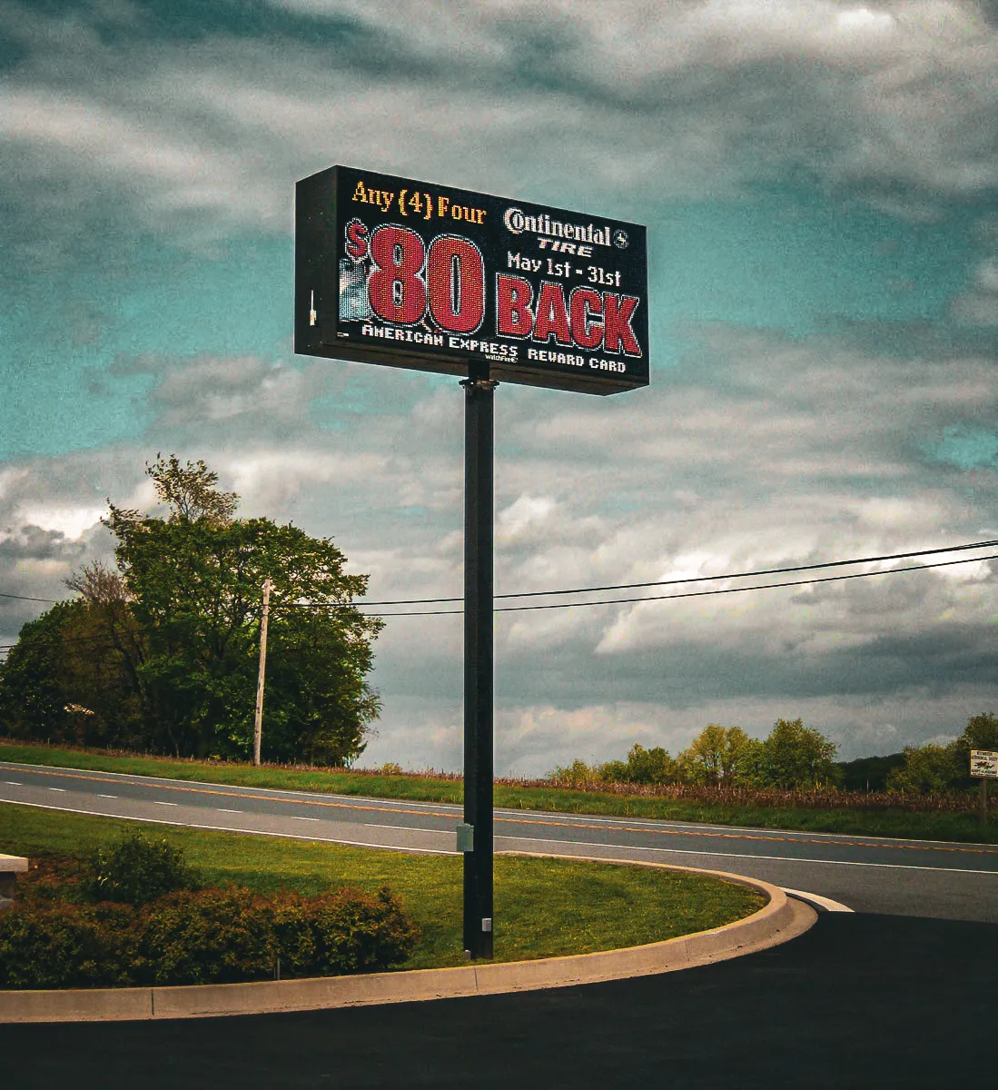 Commercial exterior digital sign advertising $80 back American Express Rewards Card