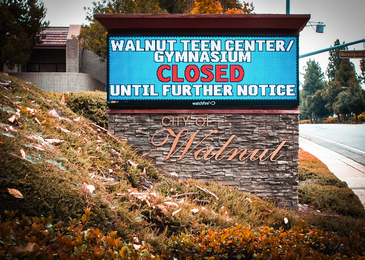 Commercial exterior sign for Walnut Teen Center with closed gymnasium notice
