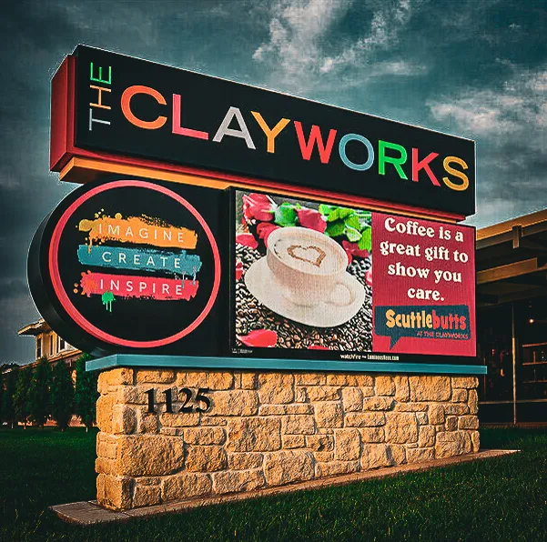 Commercial exterior sign for The Clayworks with coffee shop awning and shades