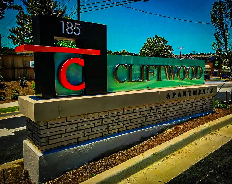 Commercial exterior signs for Cliftwood Apartments with colorful branded awnings