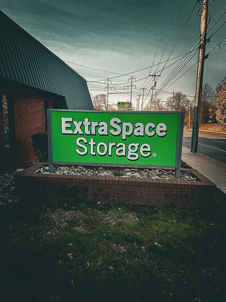 Commercial exterior sign for Extra Space Storage with green awning