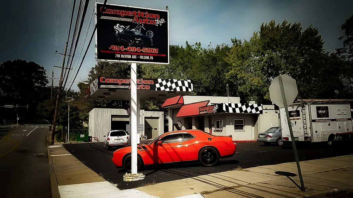Commercial Exterior with Competition Auto Signs, Awnings, and Red Sports Car