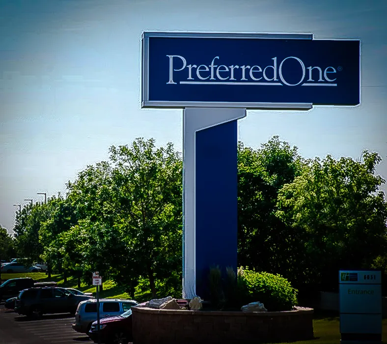 Commercial exterior with PreferredOne sign, awnings, and parking lot landscaping