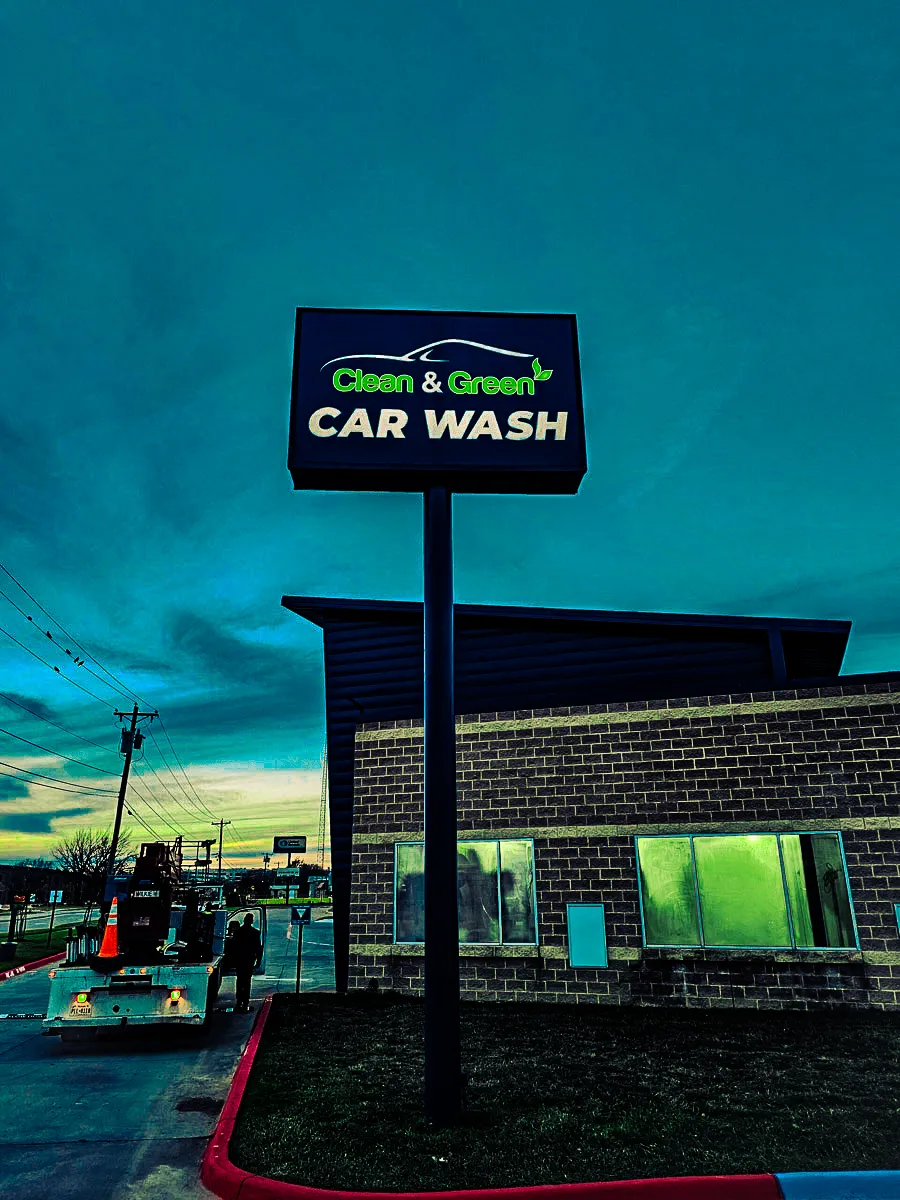 Commercial exterior of Clean & Green Car Wash with signs, awnings, and shades