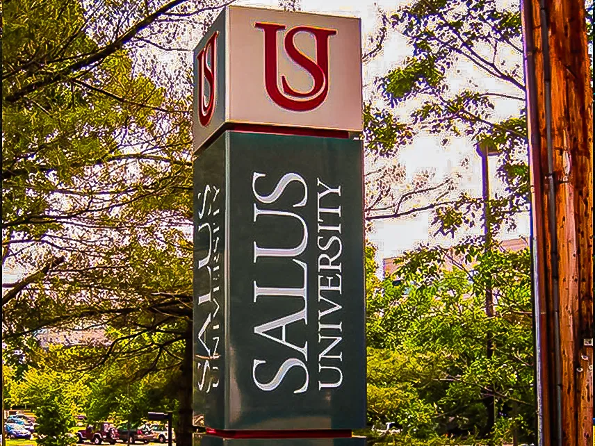 Commercial exterior sign for Salus University with shades and awnings