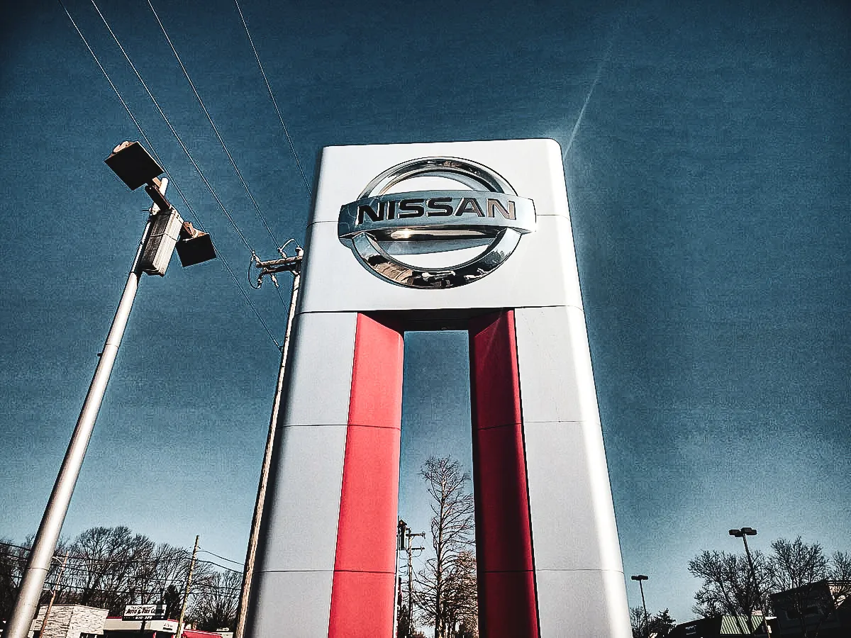 Commercial exterior Nissan sign with red and white shades, awnings
