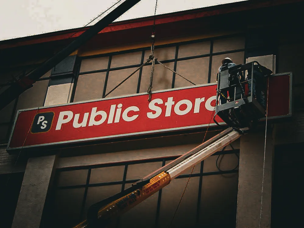 Commercial exterior sign for Public Storage with installation equipment and shades