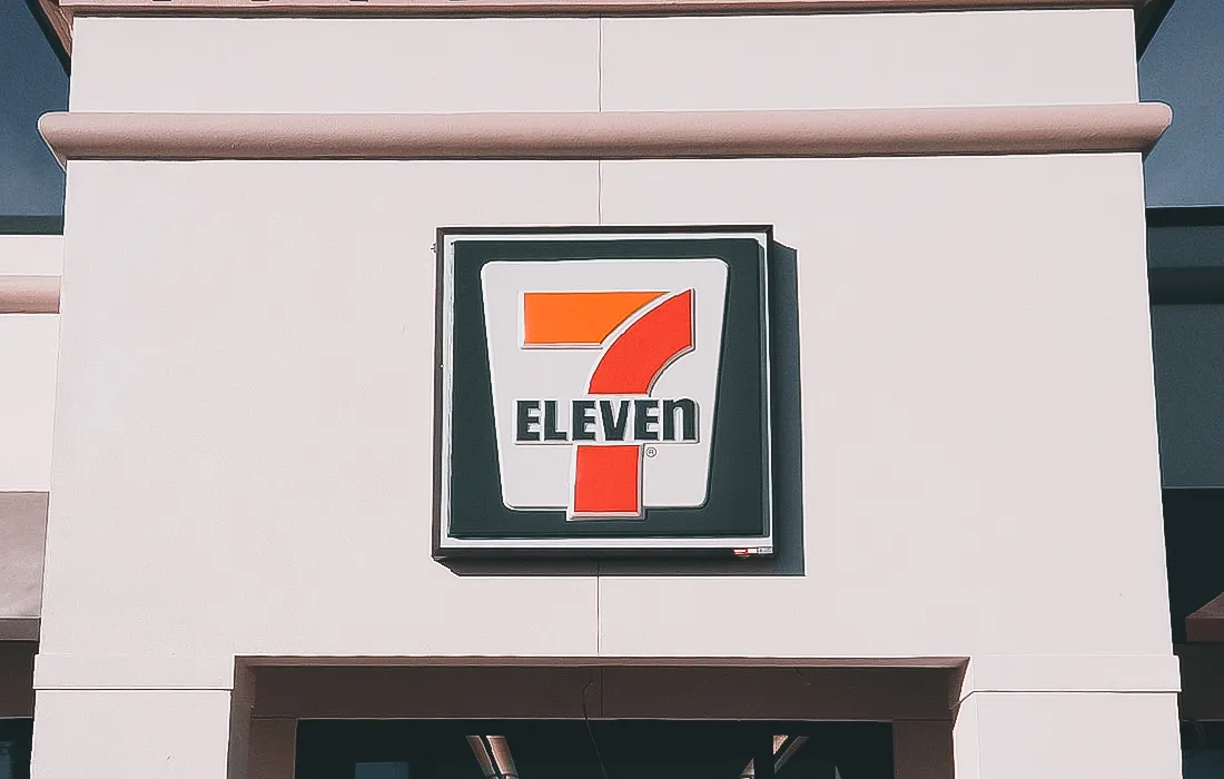 Commercial exterior with 7-Eleven sign, awnings, and branded shades