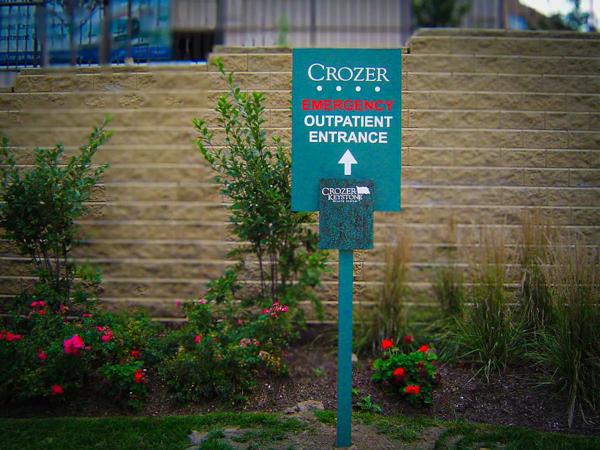 Commercial exterior sign for Crozer Emergency Outpatient Entrance with landscaped surroundings