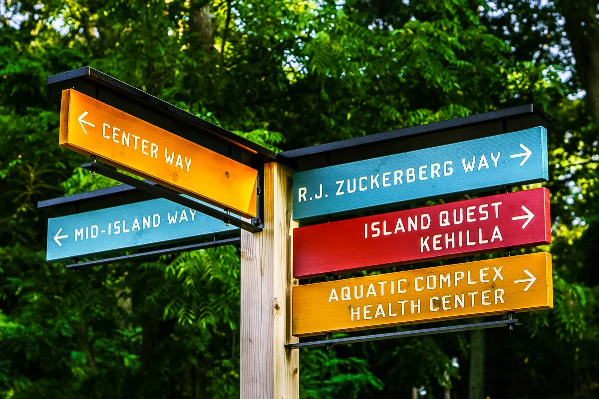 Commercial exterior signs with colorful awnings directing to various location ways