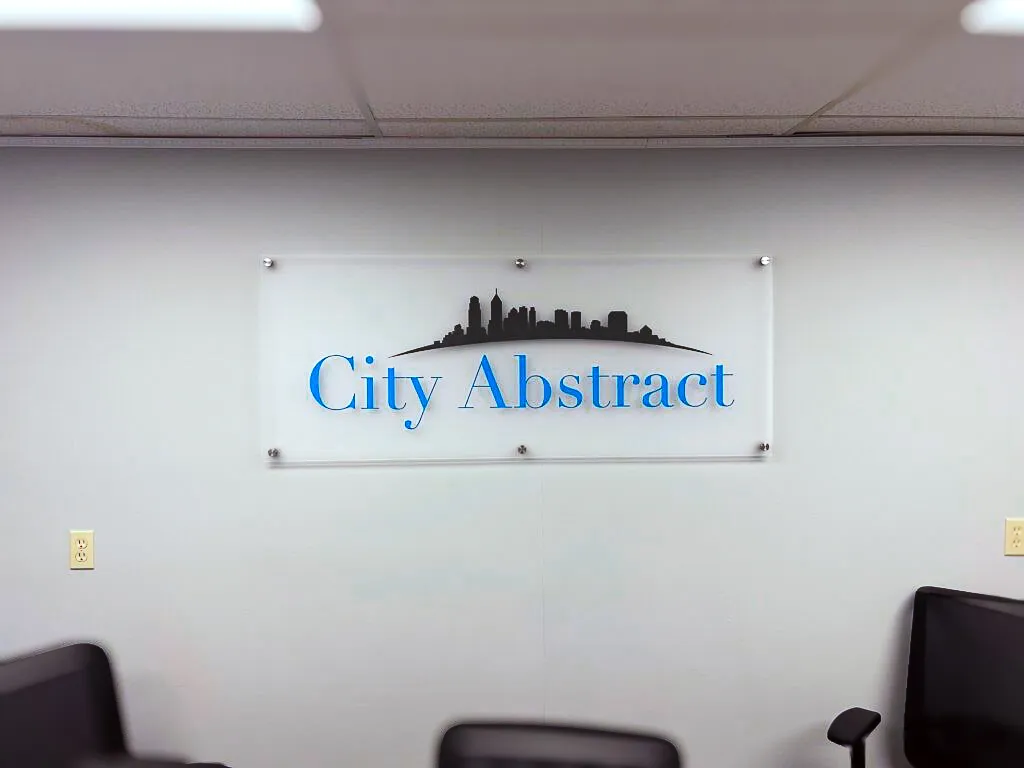 Commercial interior sign with City Abstract logo and skyline on wall