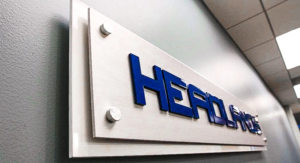 Commercial interior exterior sign with blue letters on white mounted panel