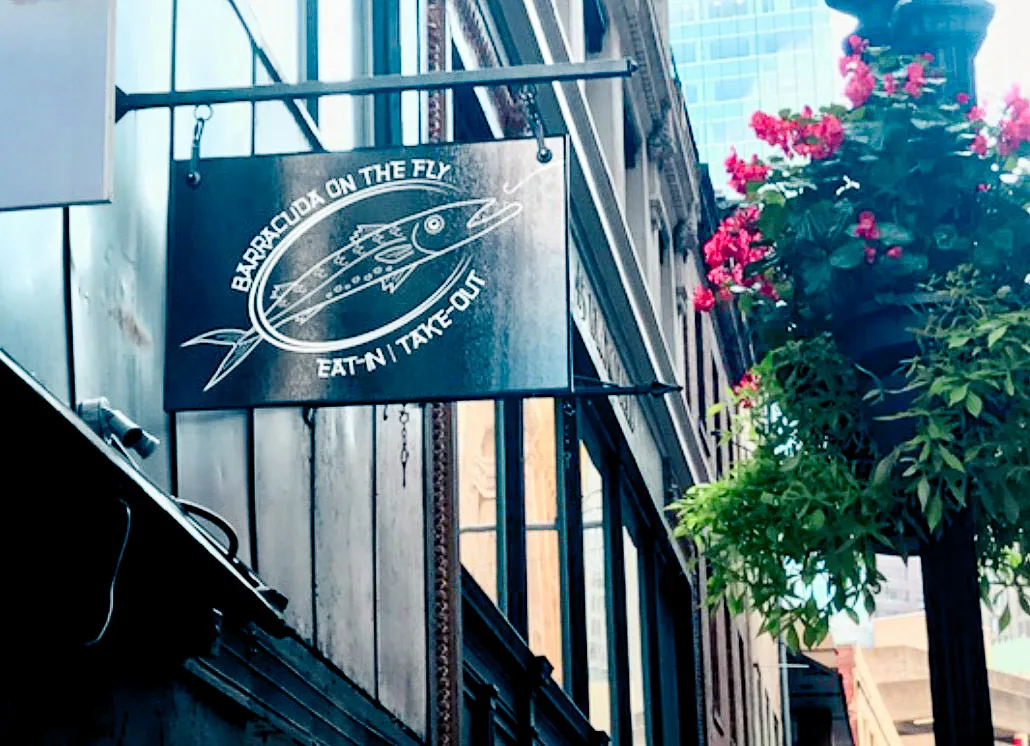 Commercial exterior sign for fish restaurant with awnings and flowering shades