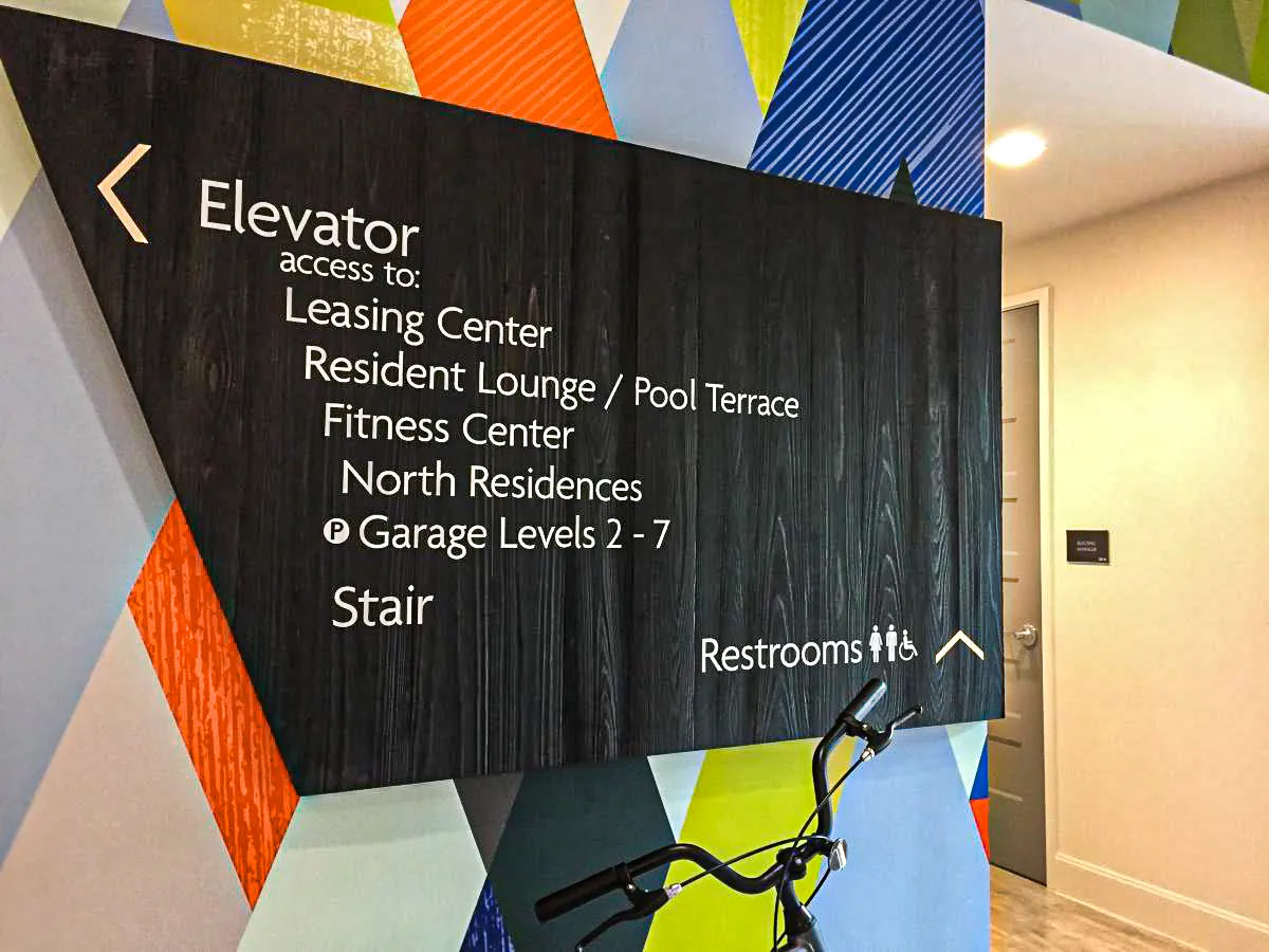 Commercial interior signage for elevator access with exterior design elements