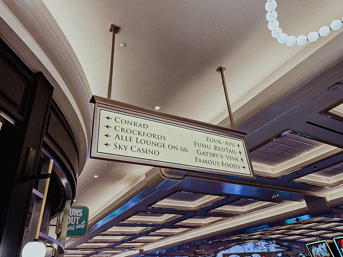 Commercial interior with hanging signs directing to restaurants and casino