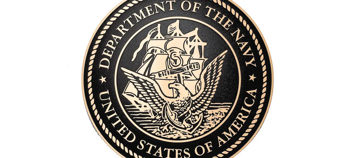 Official seal of US Department of Navy with ship and eagle emblem