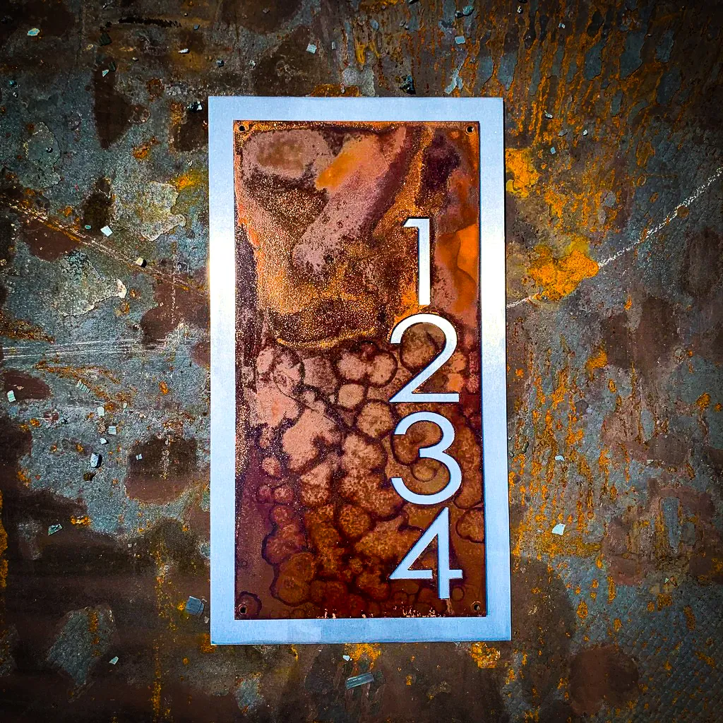 Commercial exterior signs with rusty, textured 1234 numbering on weathered wall