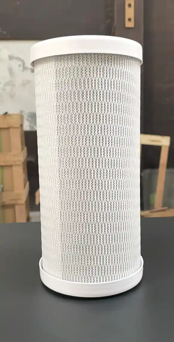 Cylindrical white water filter with a mesh pattern standing on a dark surface.