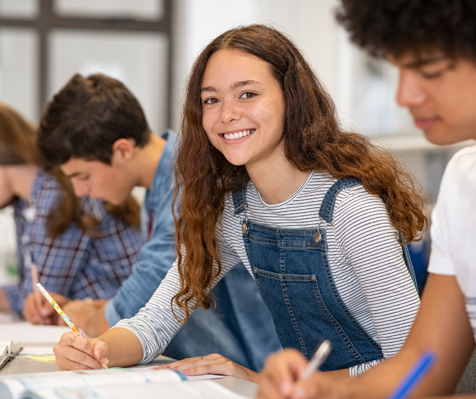 A smiling irl in the classroom.