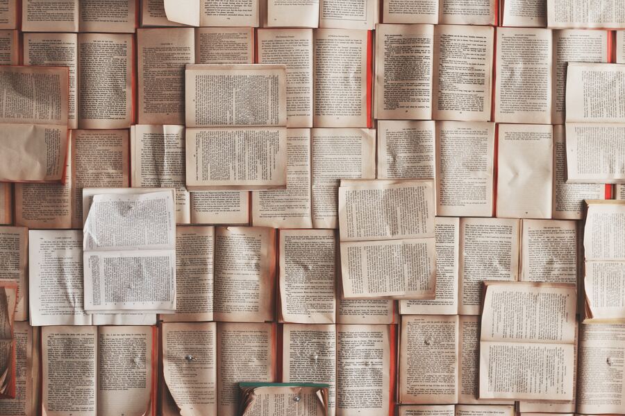 A photo of a many open books.