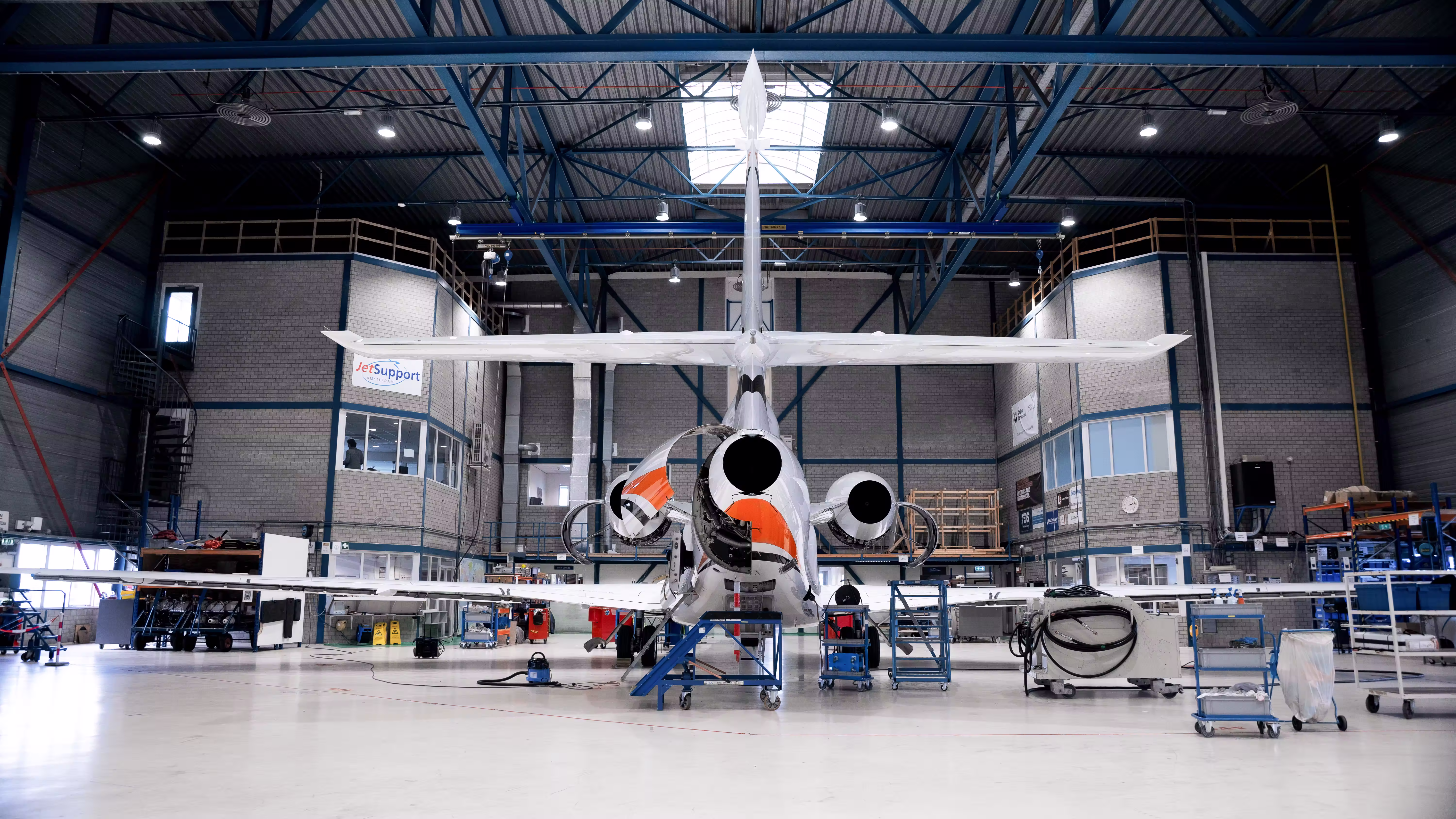 Aviation technicians conducting a pre-flight safety check on a private aircraft