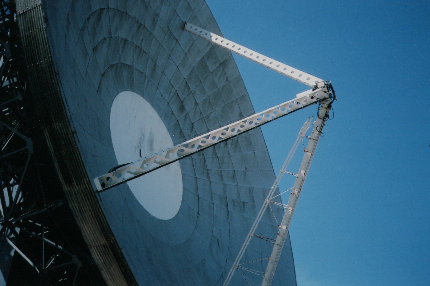 Satellite ground station dish pointed at a clear sky