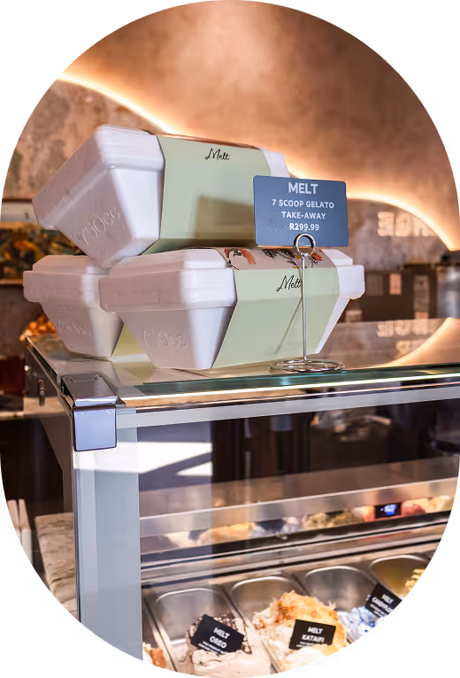A row of stainless steel gelato containers, all with different flavours at Melt.