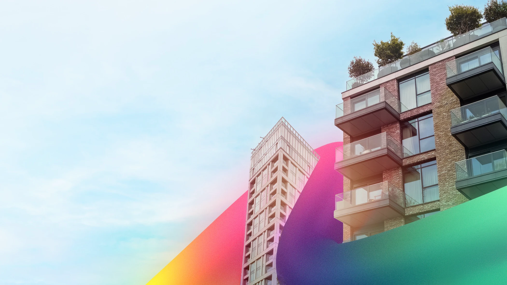 Modern apartment buildings with glass balconies against blue sky