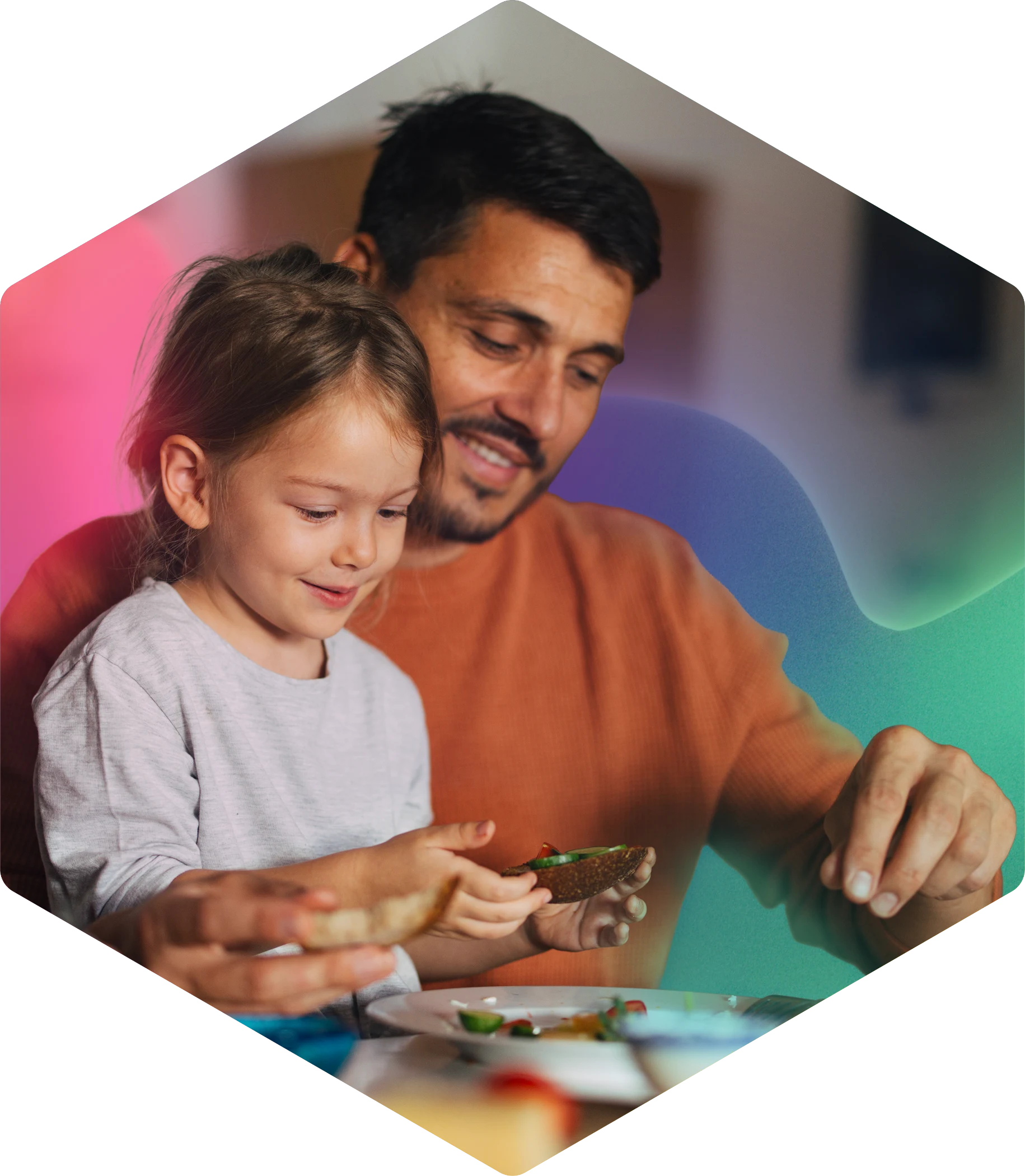 Parent and child enjoying meal together, smiling and sharing food
