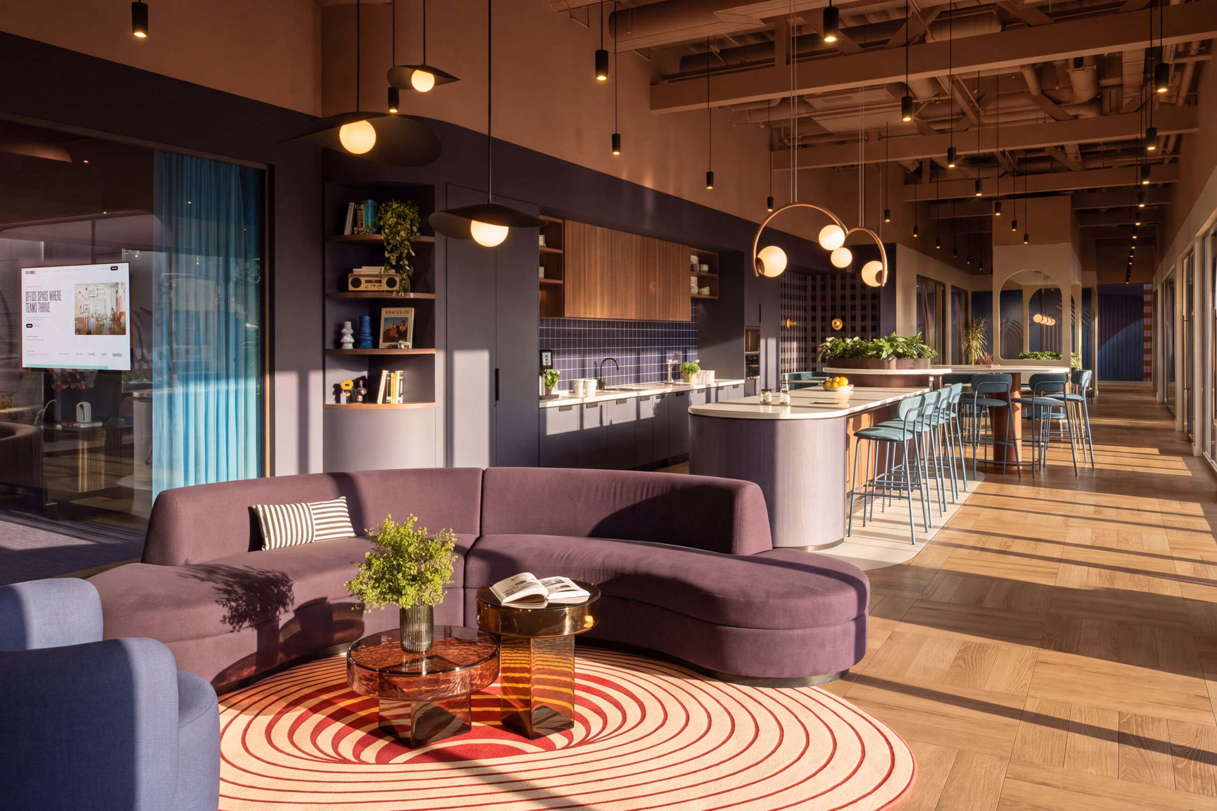 Kitchen and lounge with a curved sofa at Runway East St Paul's