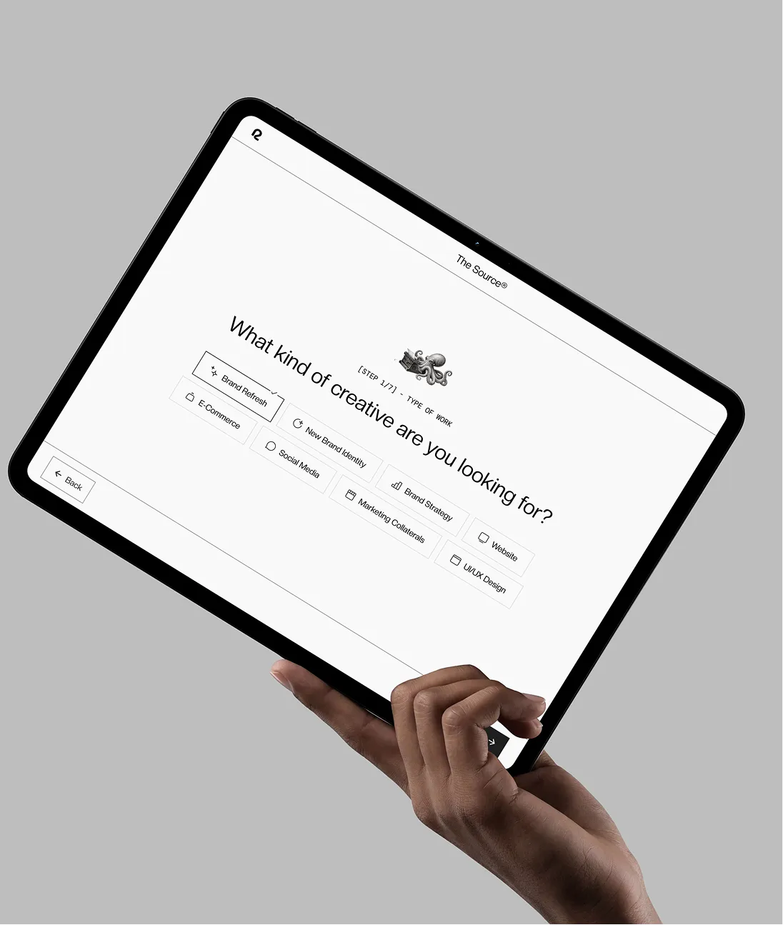 Hand holding tablet displaying a survey asking what kind of creative work is needed with various options.