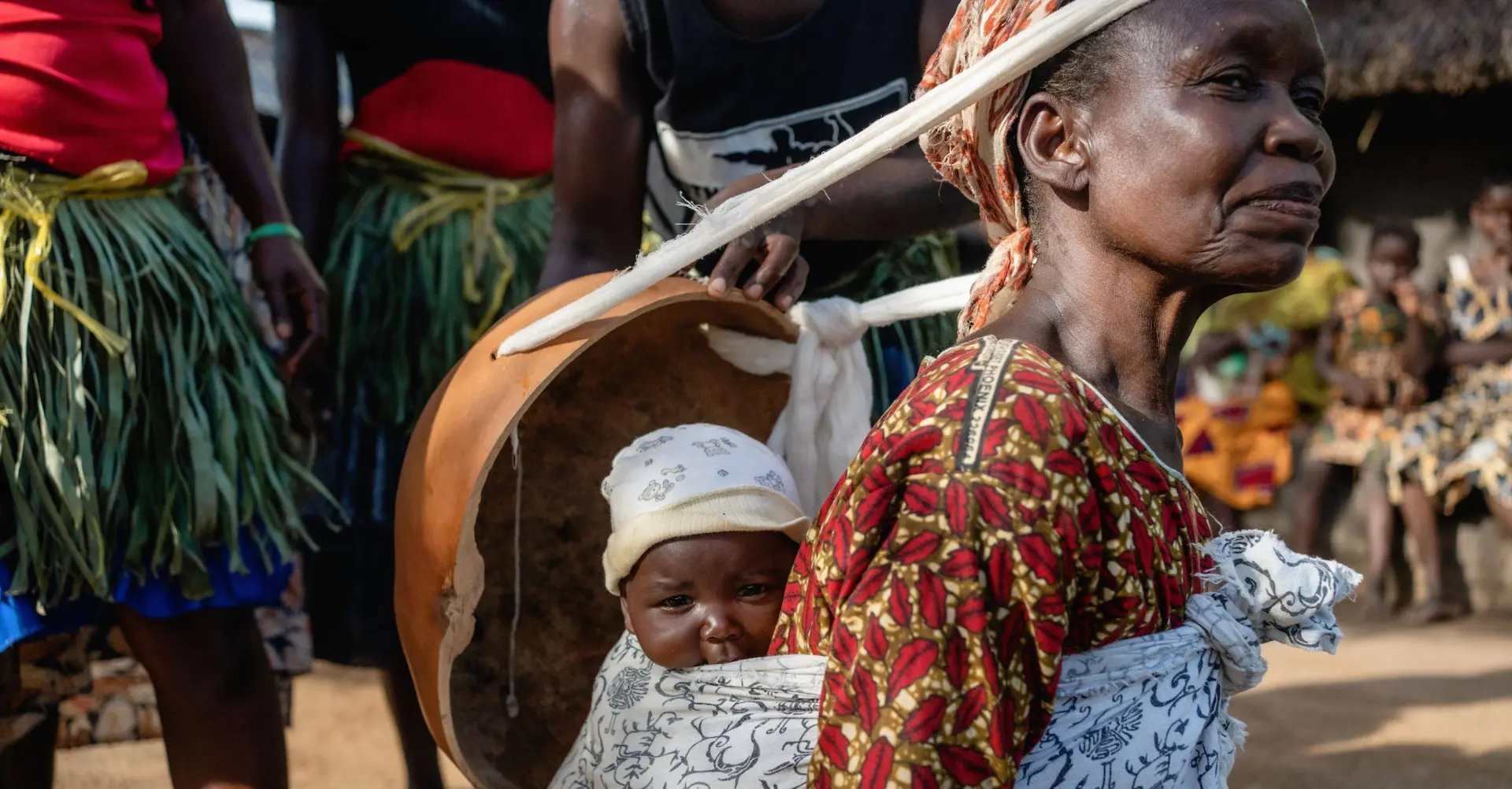 Ugandan grandmother carrying a child on her back