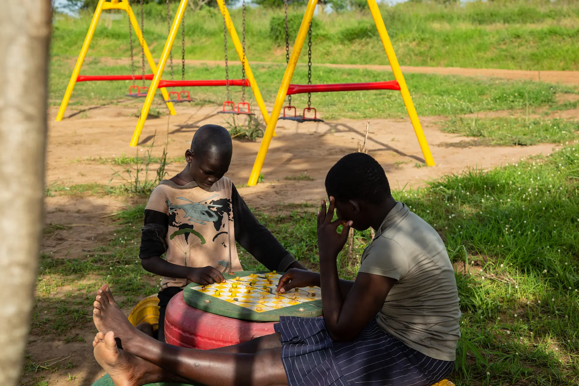 Children playing chess in the community playground close to Murchison River Lodge 