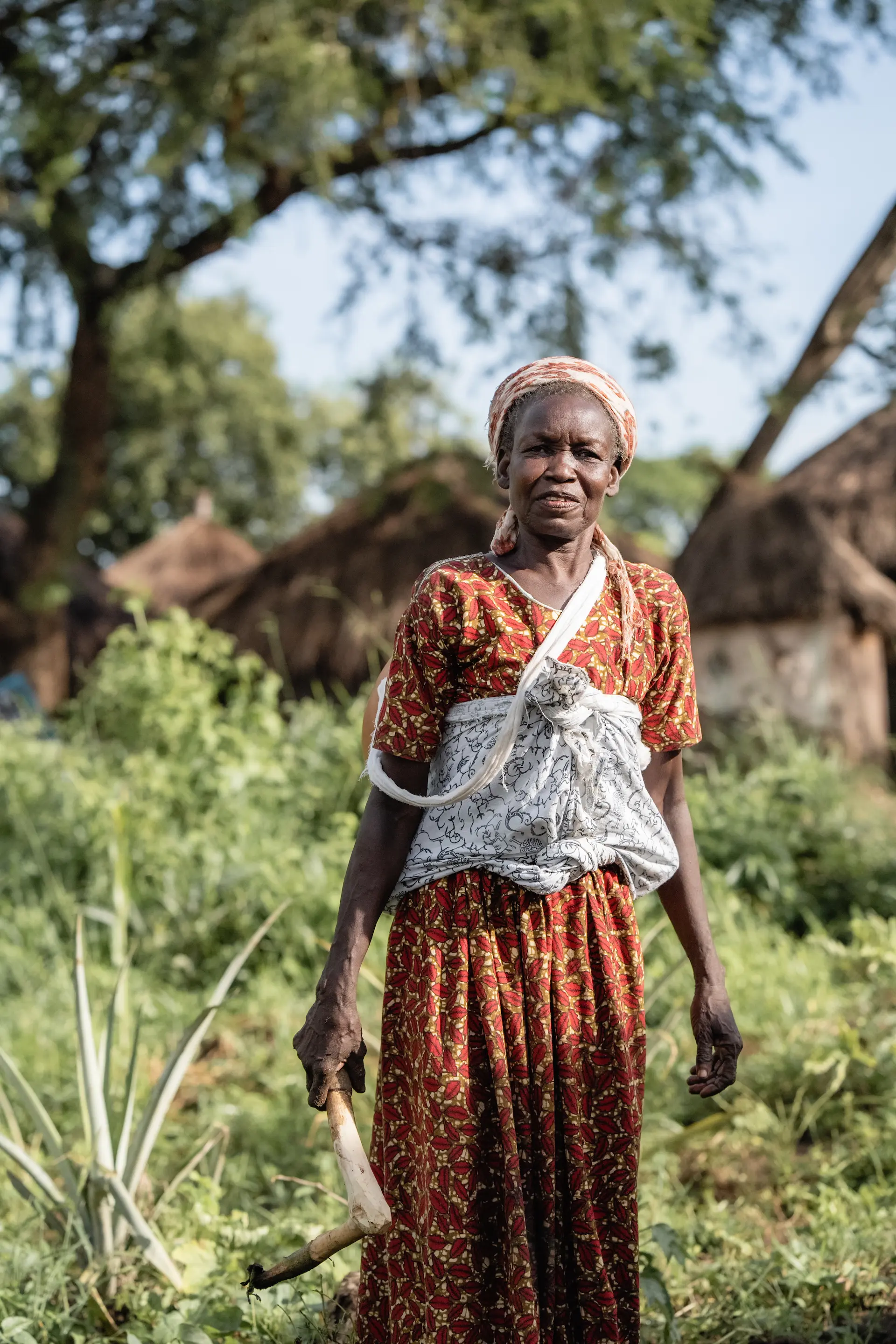 Woman elder from the community tending her garden 