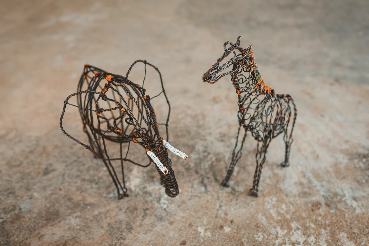 Wire giraffe and elephant made from snares found in Murchison Falls National Park