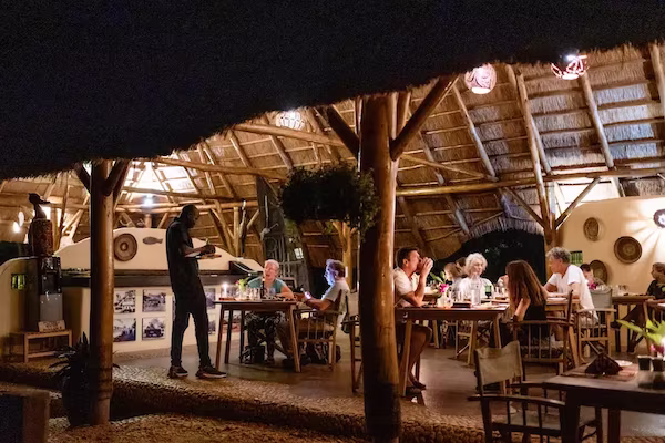 Guests enjoying dinner in the lodge restaurant at night 