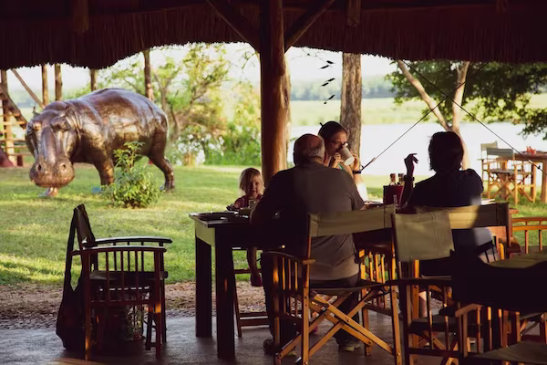 Family enjoying the restaurant with steel hippo in the background 