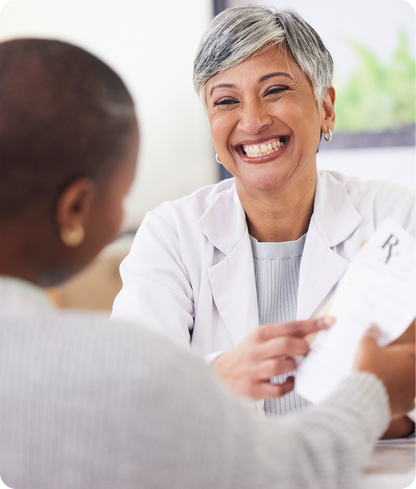 Pharmacist handing a prescription to a patient
