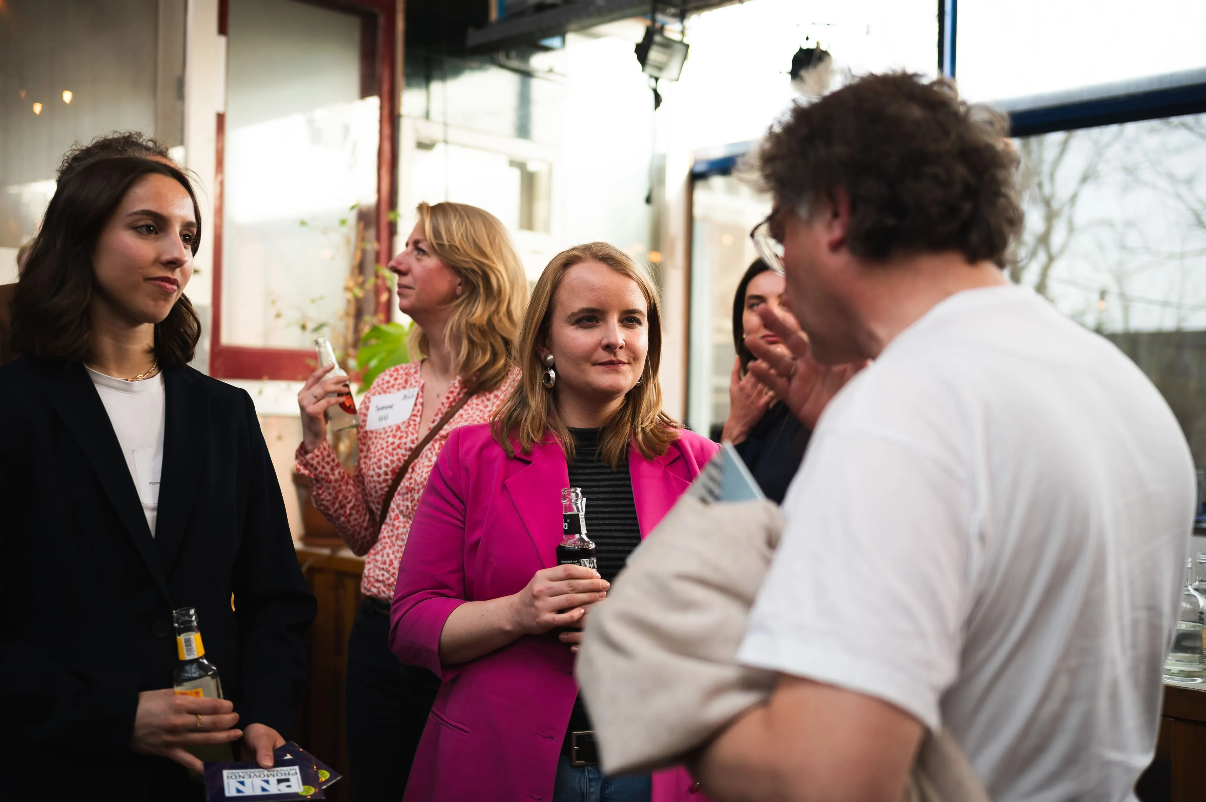 Group of professionals networking and socializing at an indoor event