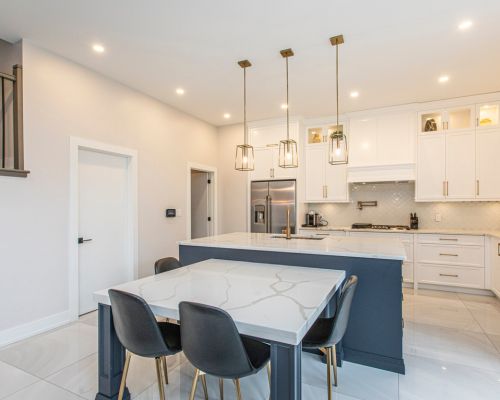 Transitional kitchen renovation with a marble backsplash and a breakfast bar