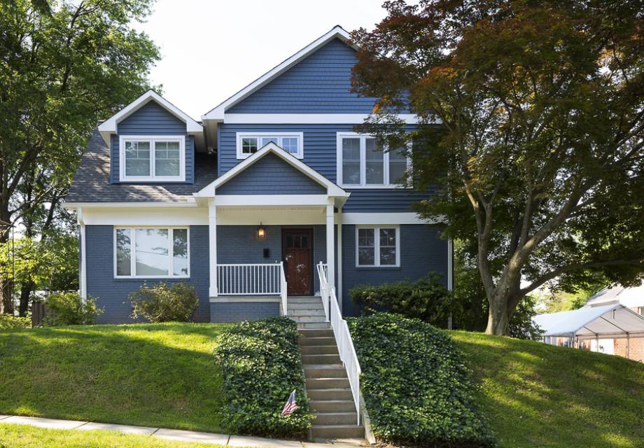 Halifax home after a second floor extension, with blue siding and a covered porch