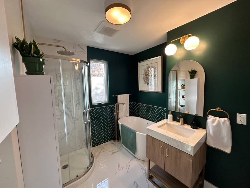 Renovated bathroom with a tiled walk-in shower and a floating vanity