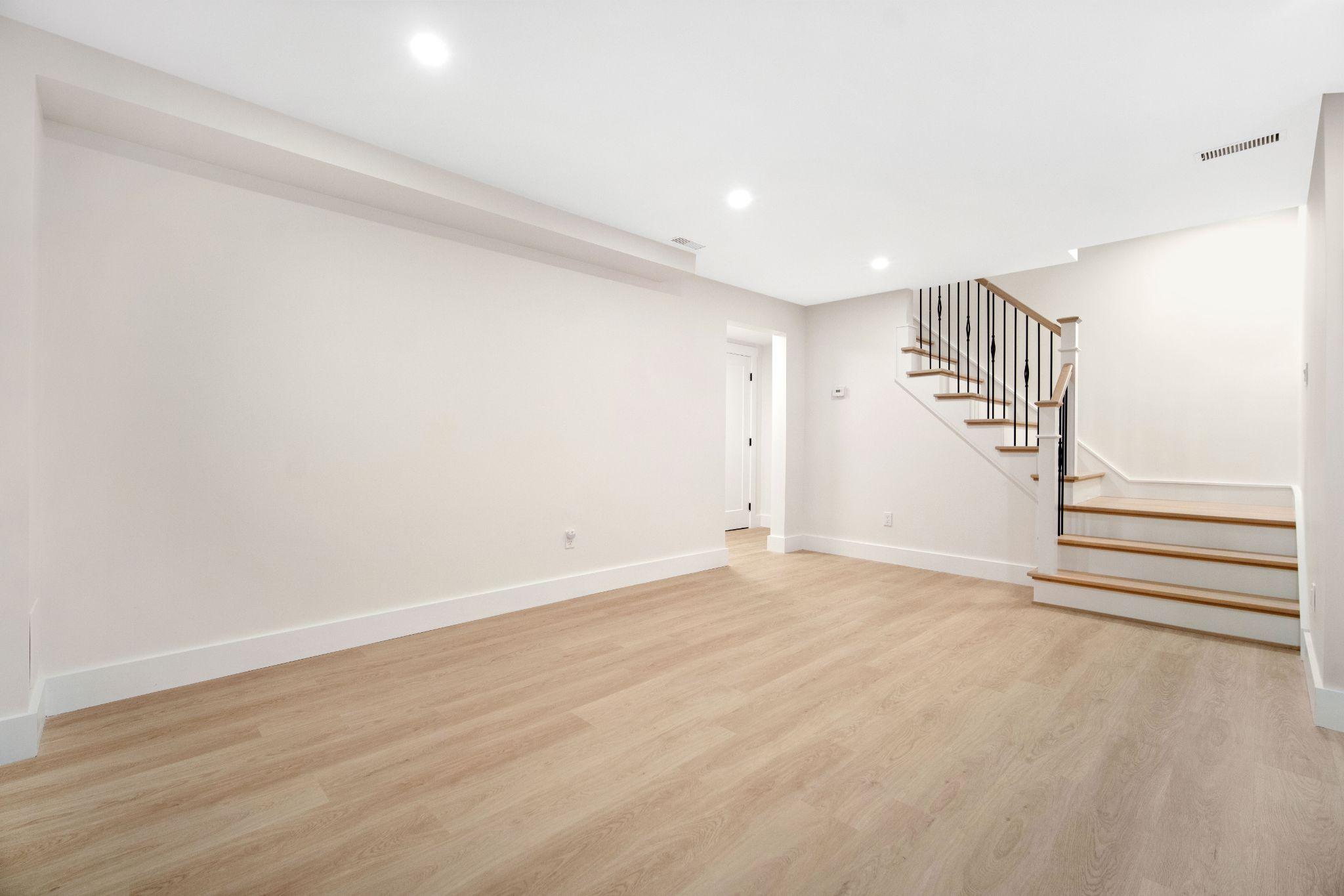 Newly finished basement shell with a staircase, ready for an apartment layout to be built out