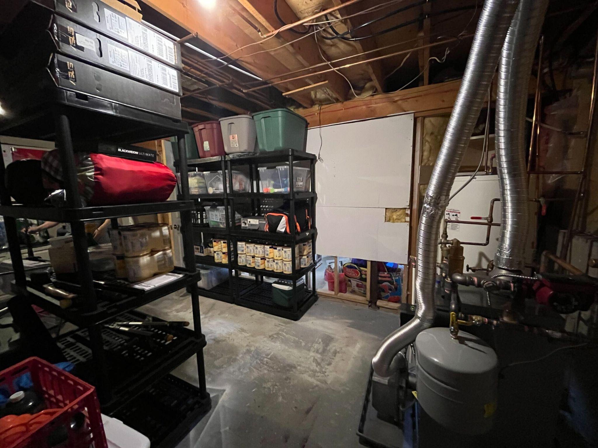 Finished stair landing leading down to a basement apartment entrance with double doors