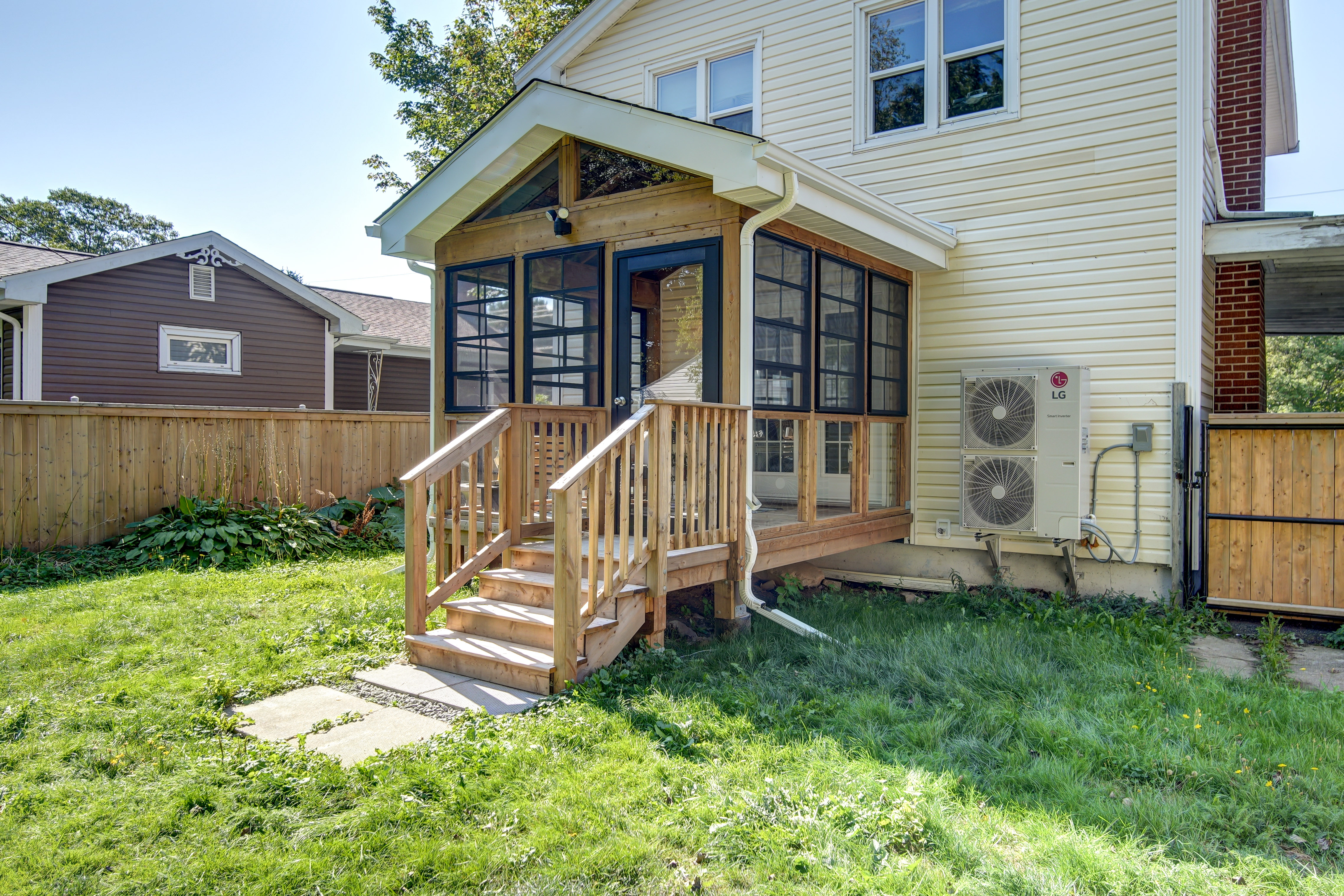 Side view of a Dartmouth addition showing the new deck stairs and the relocated heat pump