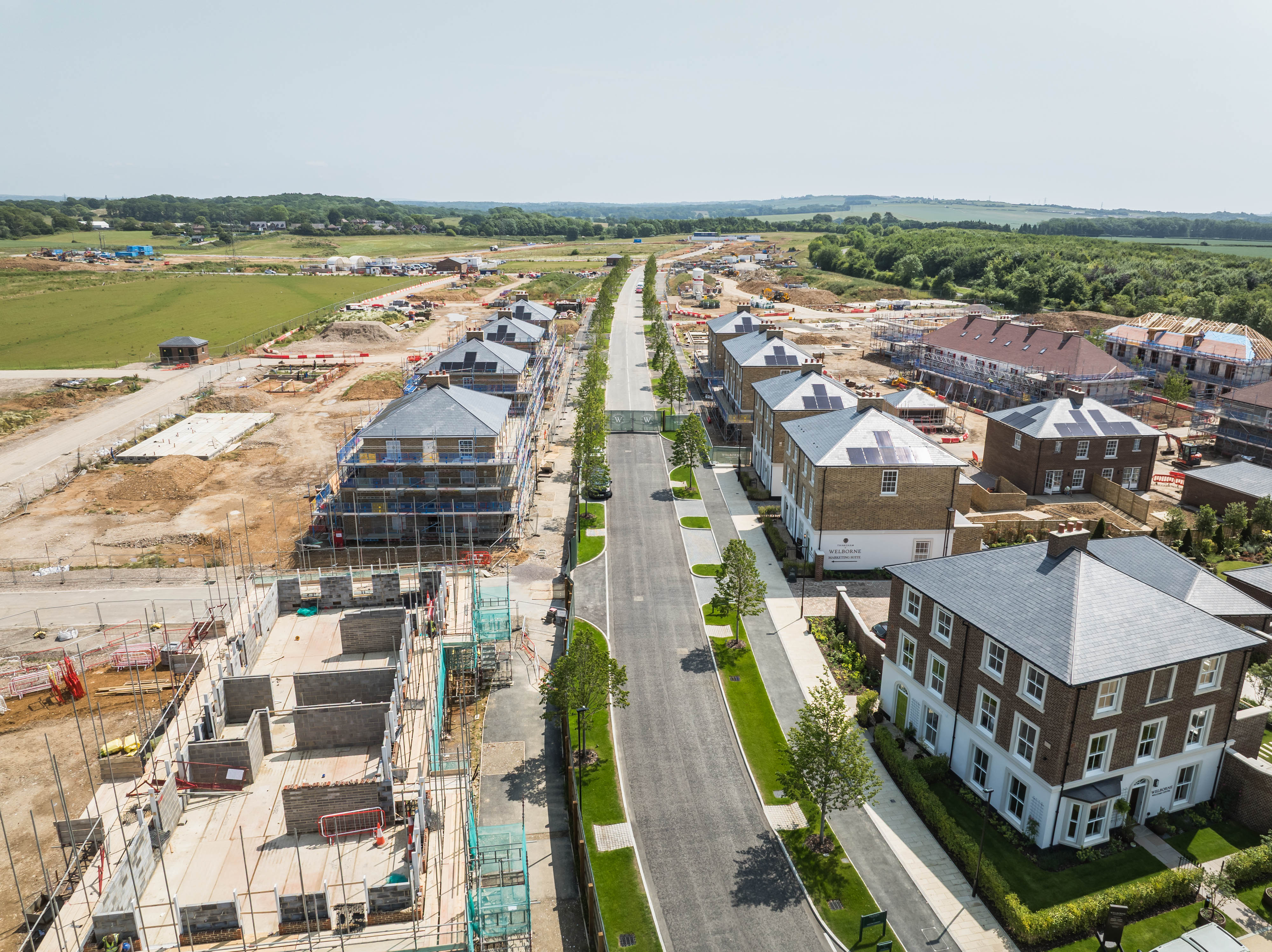 Aerial view of housing development with construction site and new buildings