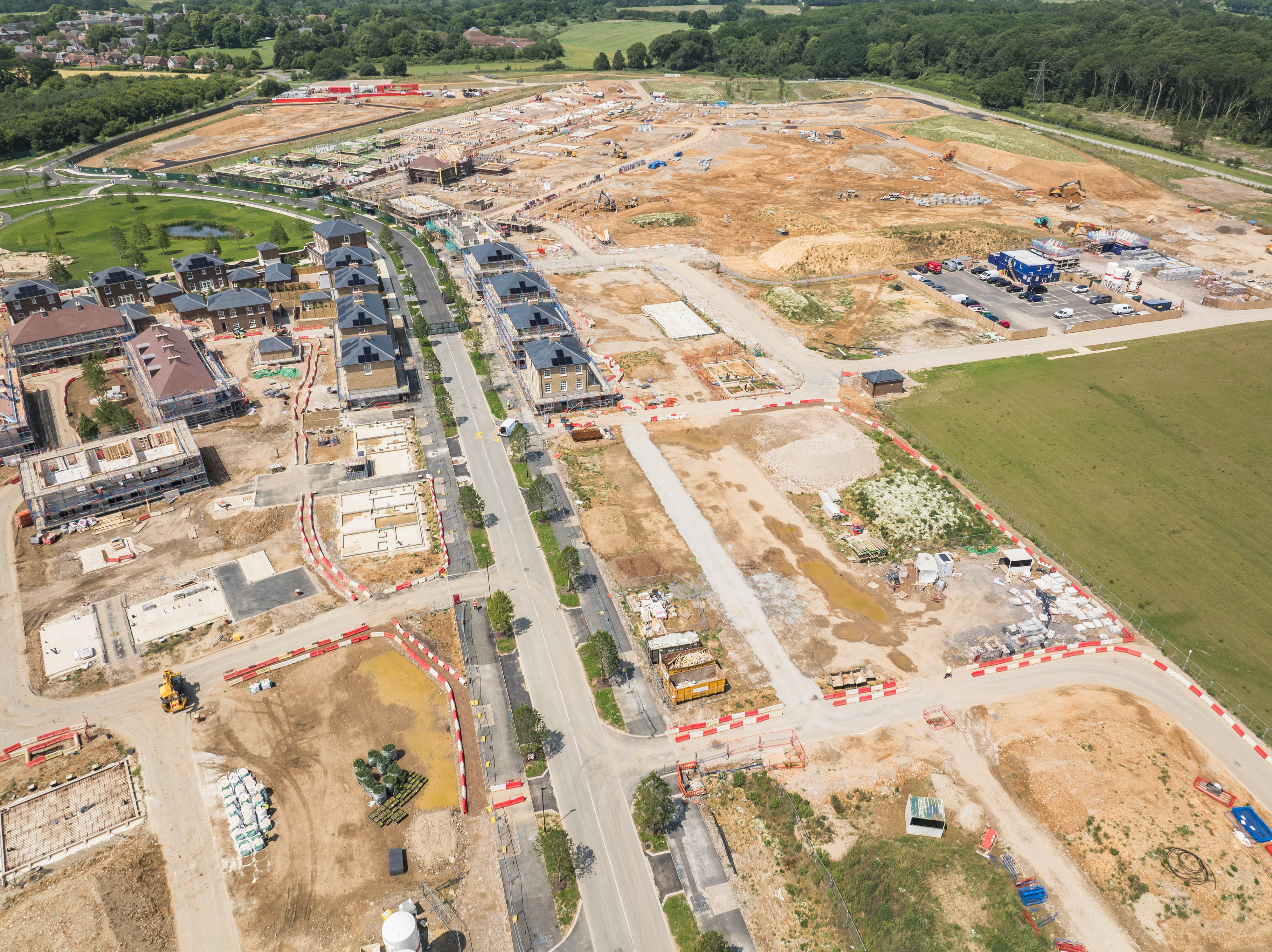 Aerial view of large housing development construction site with roads and buildings